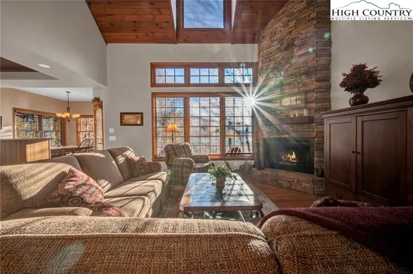 a living room with furniture and a floor to ceiling window