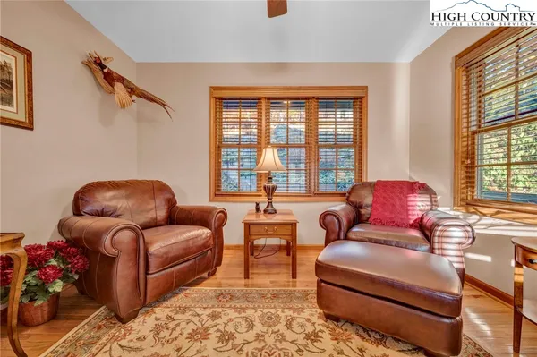 a living room with furniture a rug and a large window