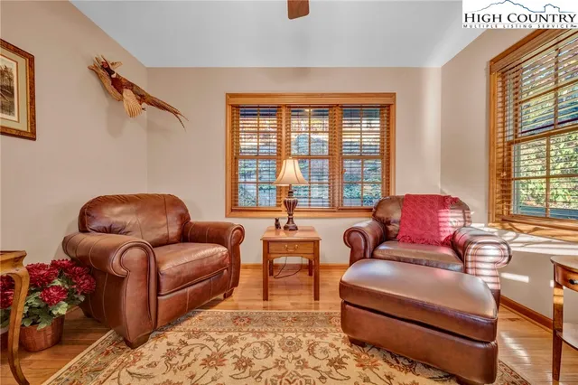 a living room with furniture a rug and a large window