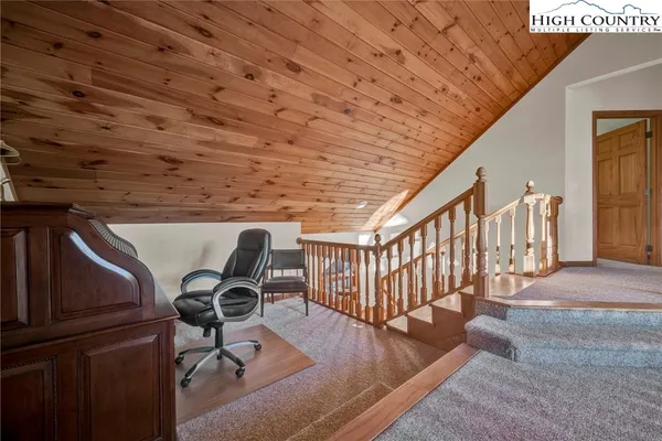 a view of workspace with wooden floor and furniture