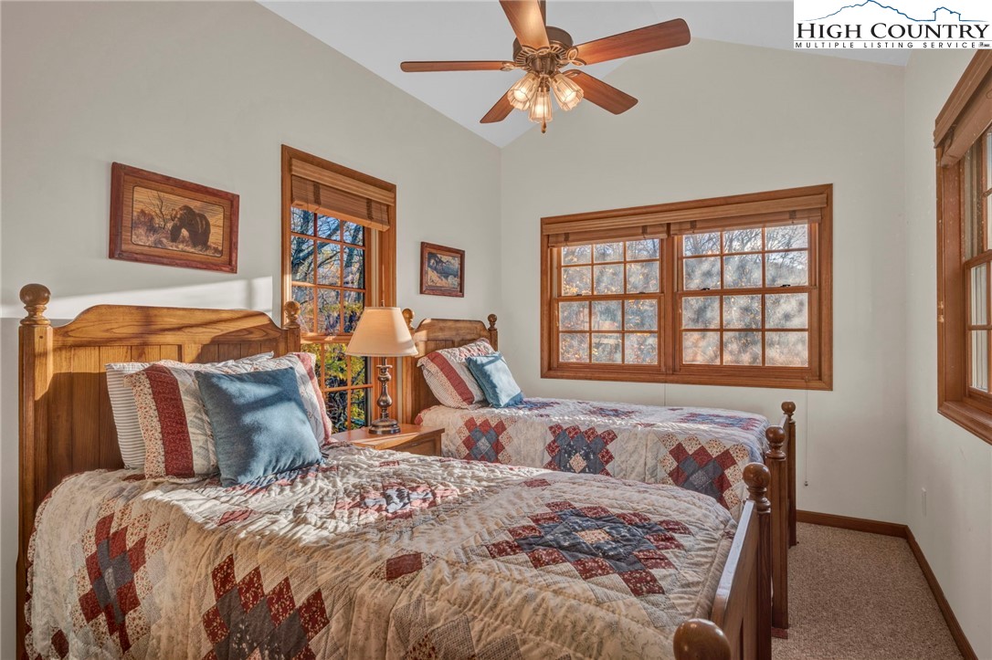 121 Spruce Hollow Road Beech Mountain, NC 28604 - Photo 30 of 50 a bedroom with a bed and wooden floor