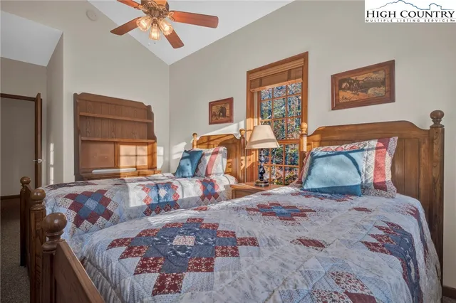 a bedroom with bed and wooden floor