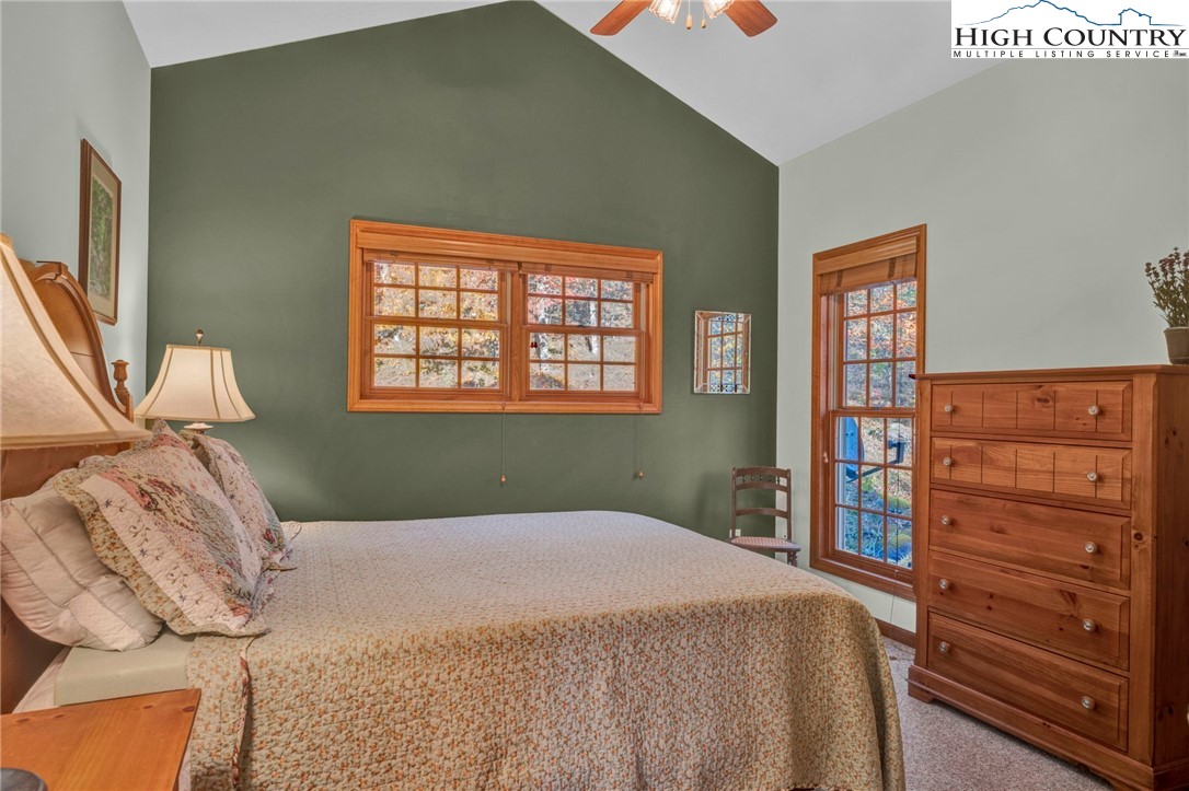121 Spruce Hollow Road Beech Mountain, NC 28604 - Photo 32 of 50 a bedroom with a bed and a dresser