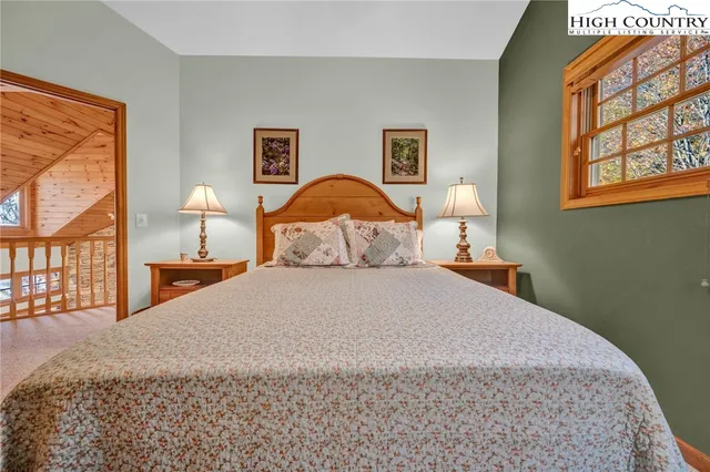 a bedroom with a bed and a painting on the wall