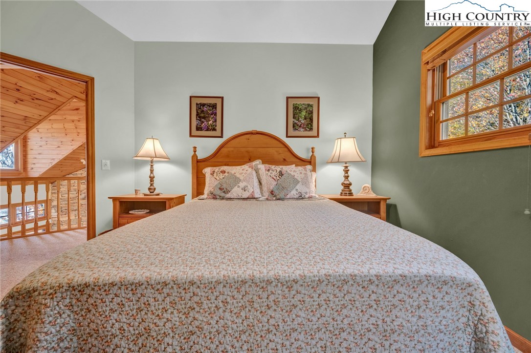 121 Spruce Hollow Road Beech Mountain, NC 28604 - Photo 33 of 50 a bedroom with a bed and a painting on the wall
