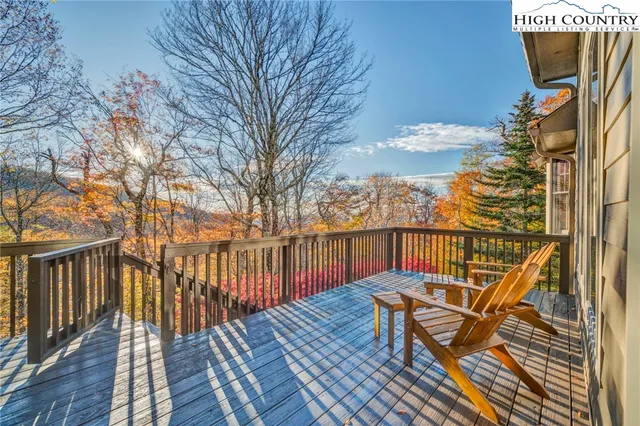 a view of balcony with wooden floor and outdoor seating