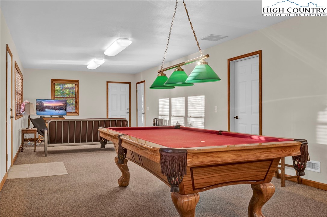 121 Spruce Hollow Road Beech Mountain, NC 28604 - Photo 39 of 50 a bedroom with a bed and a table