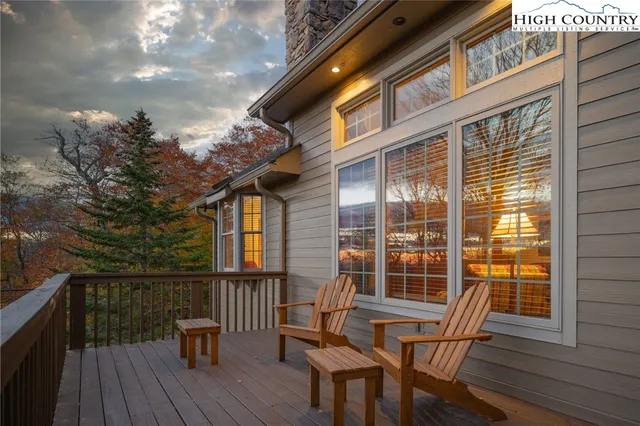 a view of balcony with wooden floor and outdoor seating