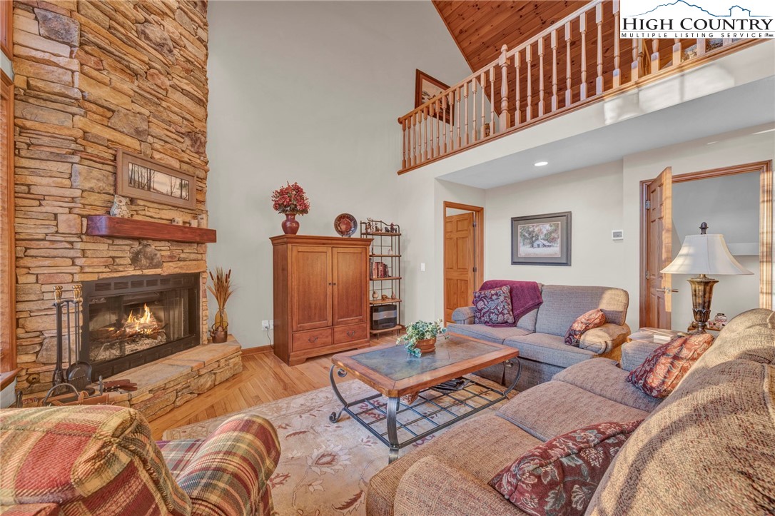 121 Spruce Hollow Road Beech Mountain, NC 28604 - Photo 47 of 50 a living room with furniture a fireplace and a flat screen tv
