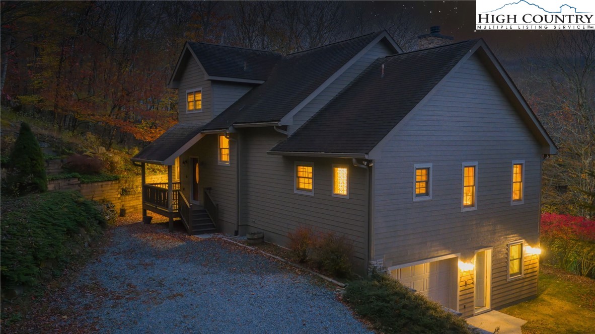 121 Spruce Hollow Road Beech Mountain, NC 28604 - Photo 10 of 50 a front view of a house with lots of green space