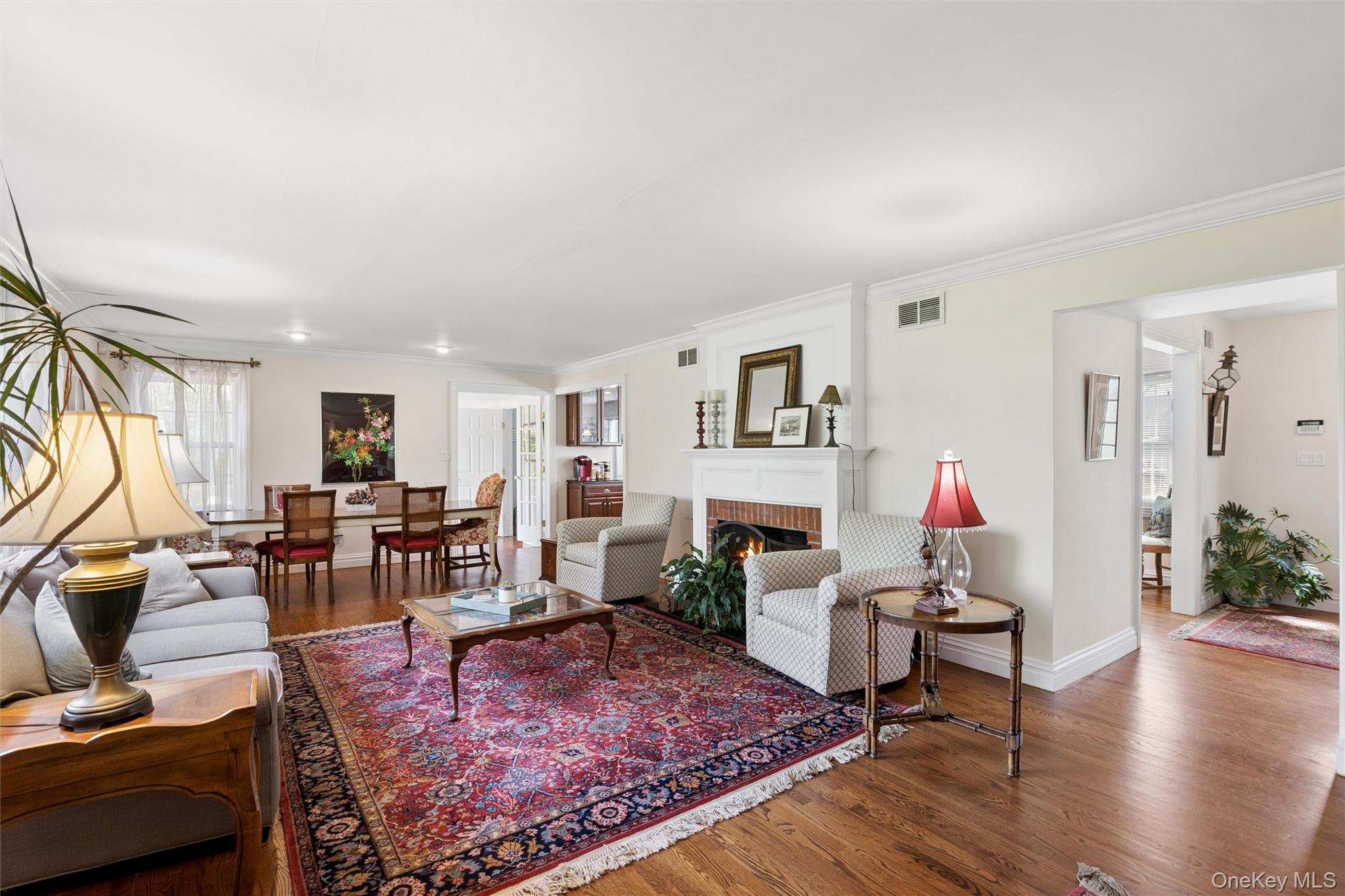 50 Belton Road Babylon, NY 11702 - Photo 13 of 34 Beautiful sunny living room with fireplace and hardwood floors and spacious dining area.