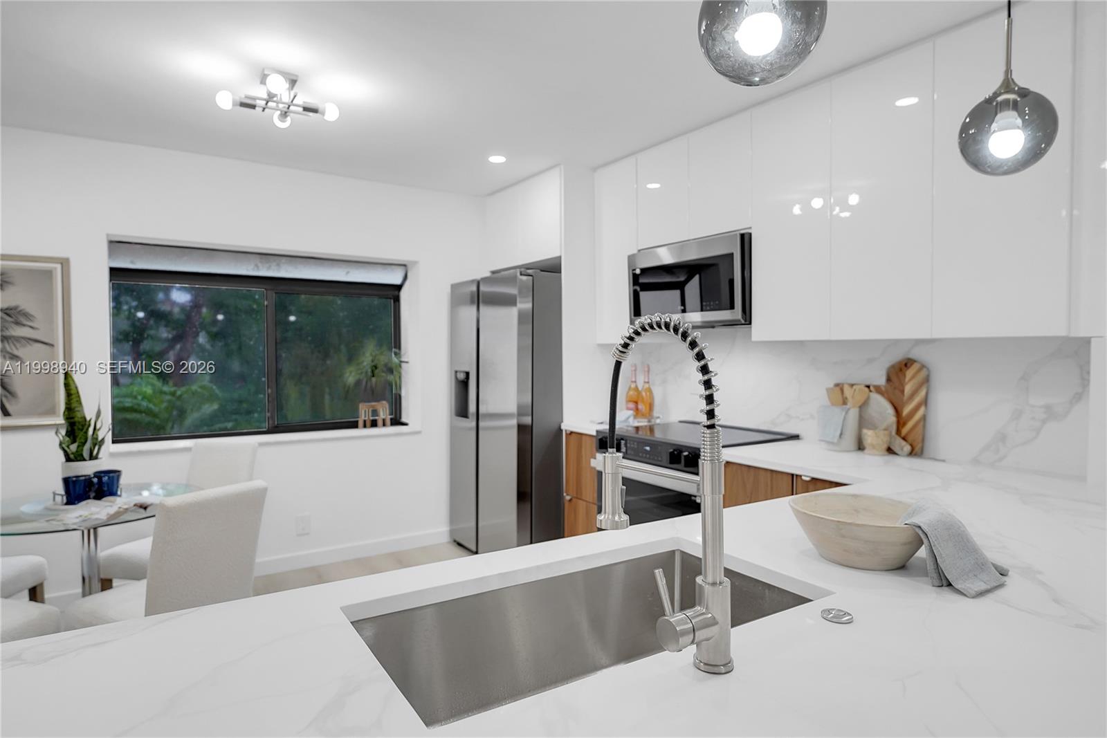7736 La Mirada Drive Boca Raton, FL 33433 - Photo 15 of 56 a kitchen with stainless steel appliances granite countertop a sink and a refrigerator
