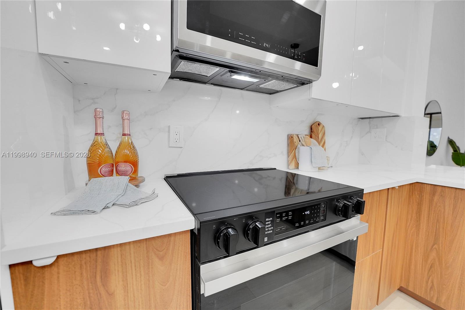 7736 La Mirada Drive Boca Raton, FL 33433 - Photo 18 of 56 a kitchen with stainless steel appliances granite countertop a stove and a sink
