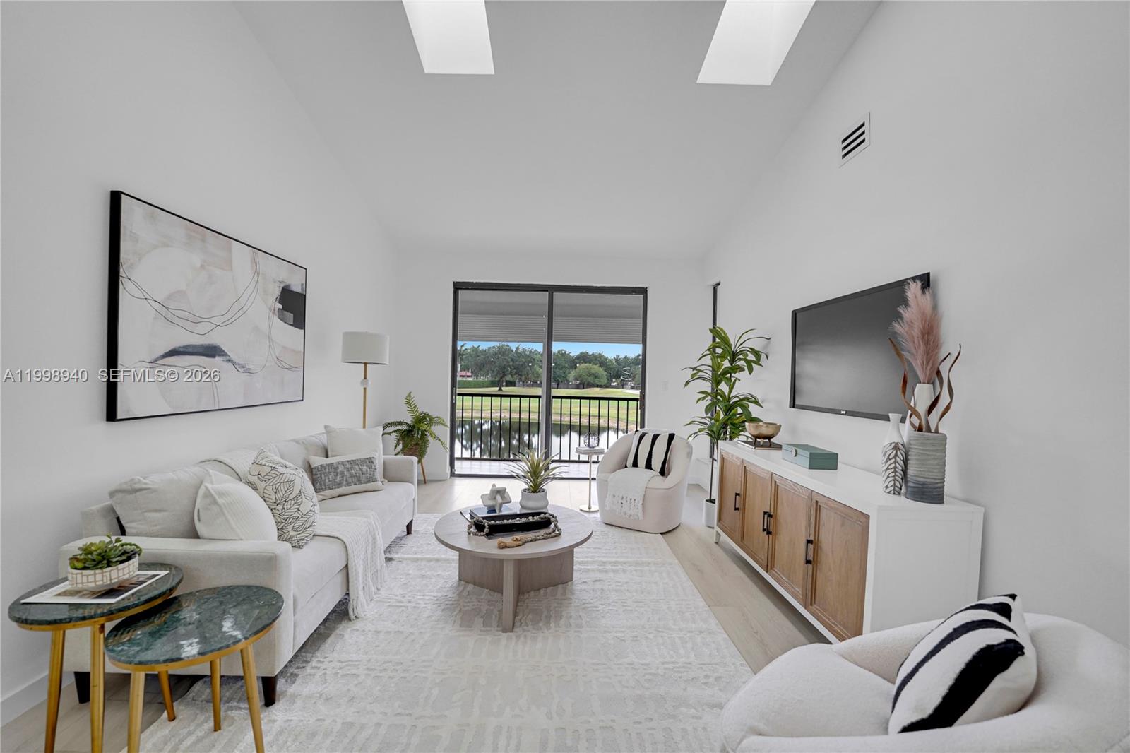 7736 La Mirada Drive Boca Raton, FL 33433 - Photo 20 of 56 a living room with furniture a flat screen tv and a large window