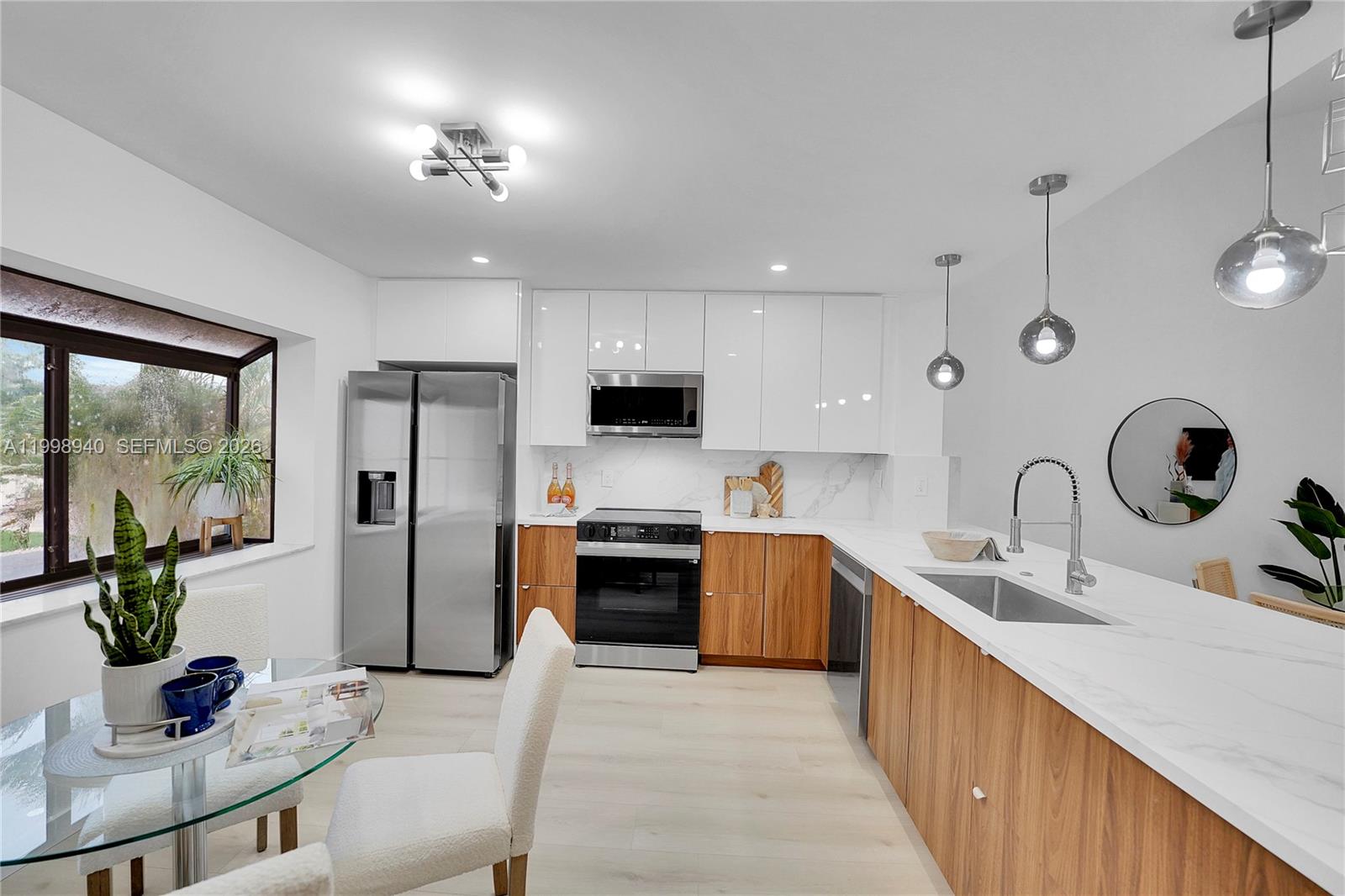 7736 La Mirada Drive Boca Raton, FL 33433 - Photo 21 of 56 a kitchen with stainless steel appliances granite countertop a sink refrigerator stove and refrigerator