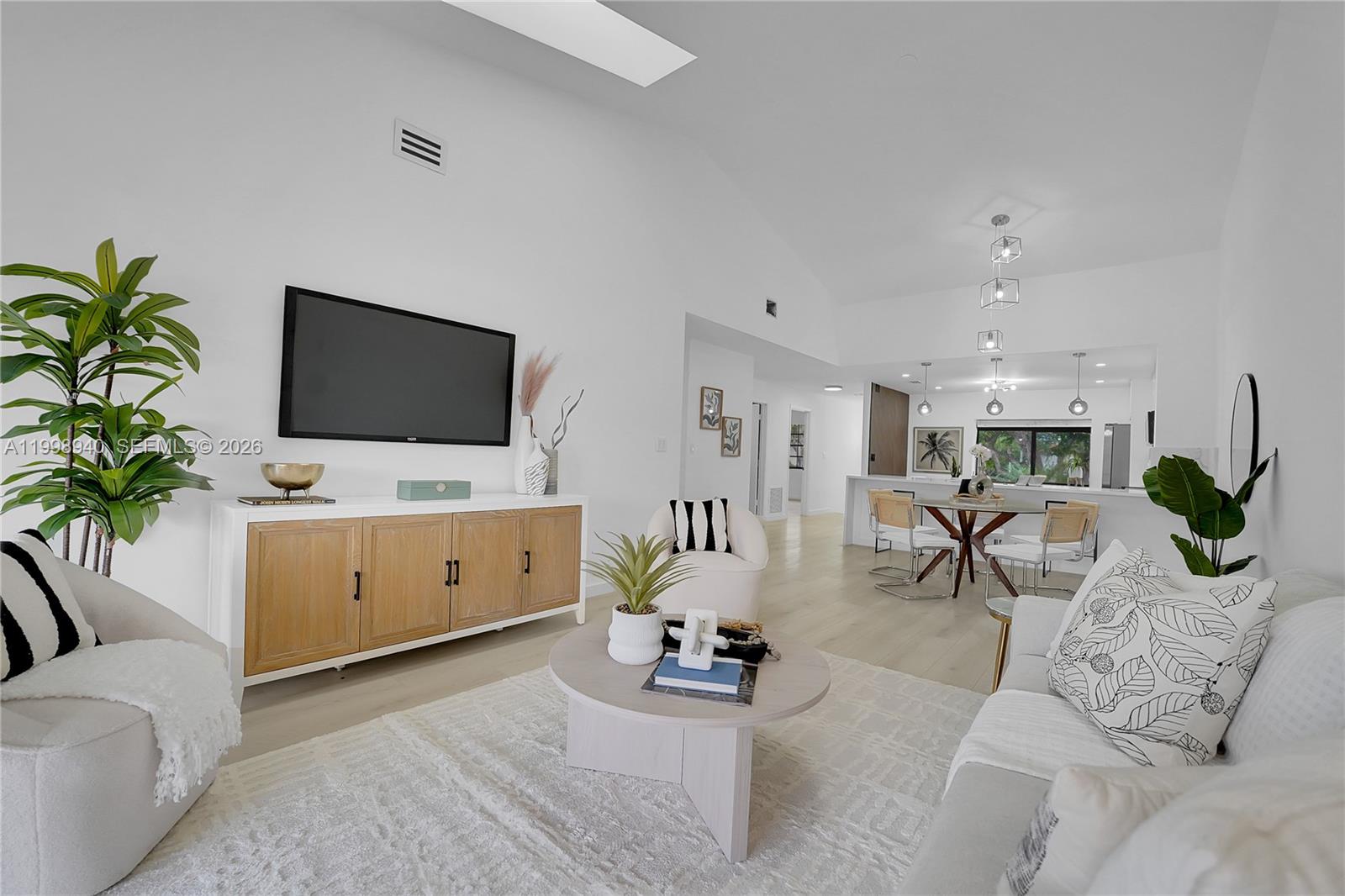 7736 La Mirada Drive Boca Raton, FL 33433 - Photo 24 of 56 a living room with furniture a potted plant and a flat screen tv