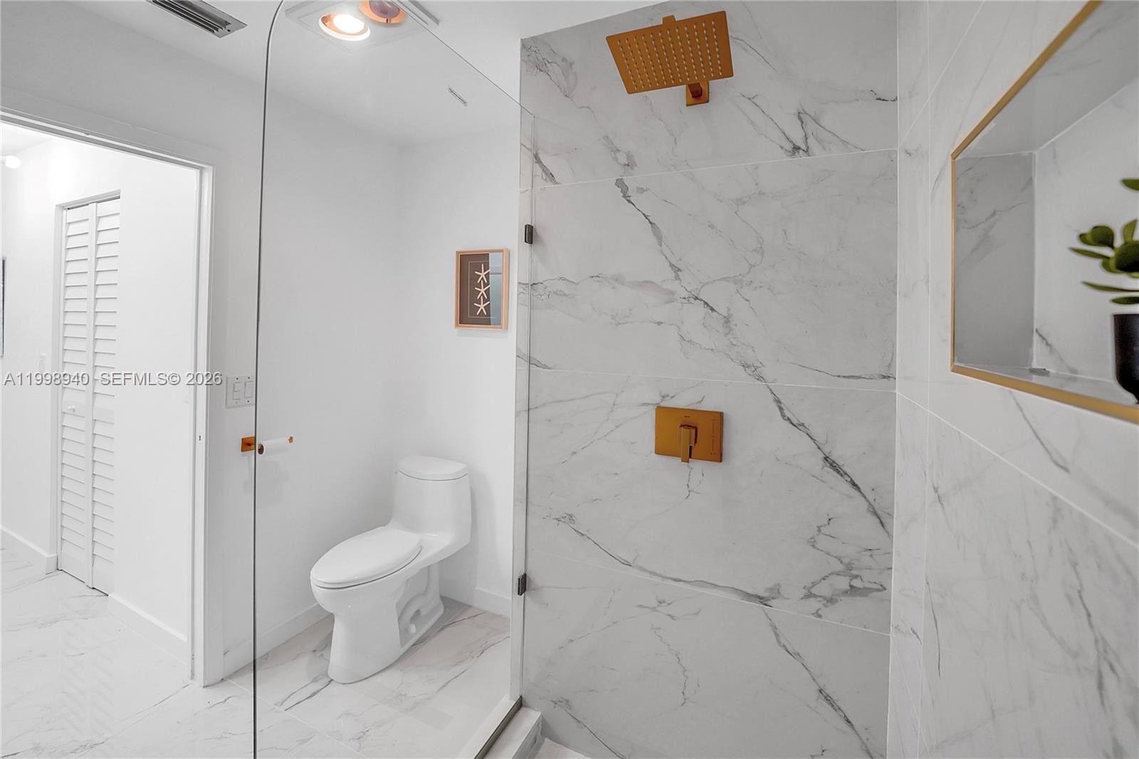 7736 La Mirada Drive Boca Raton, FL 33433 - Photo 30 of 56 a bathroom with a toilet and a shower