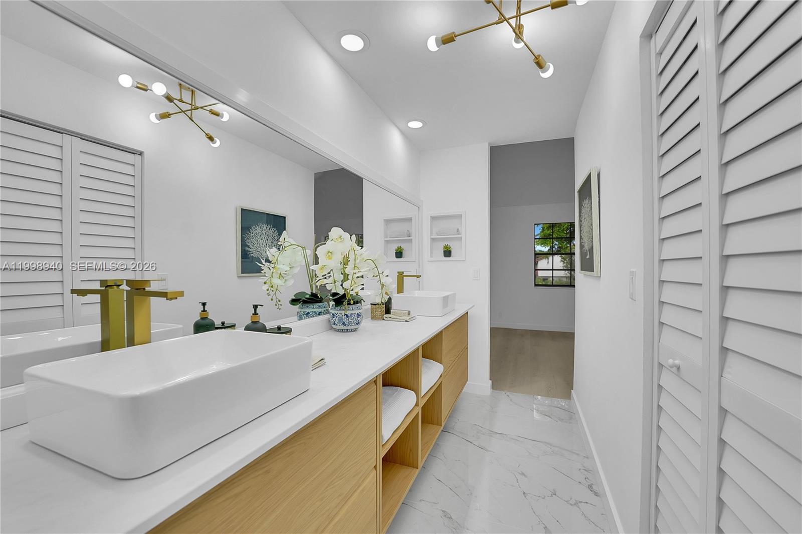 7736 La Mirada Drive Boca Raton, FL 33433 - Photo 33 of 56 a bathroom with a sink and a mirror