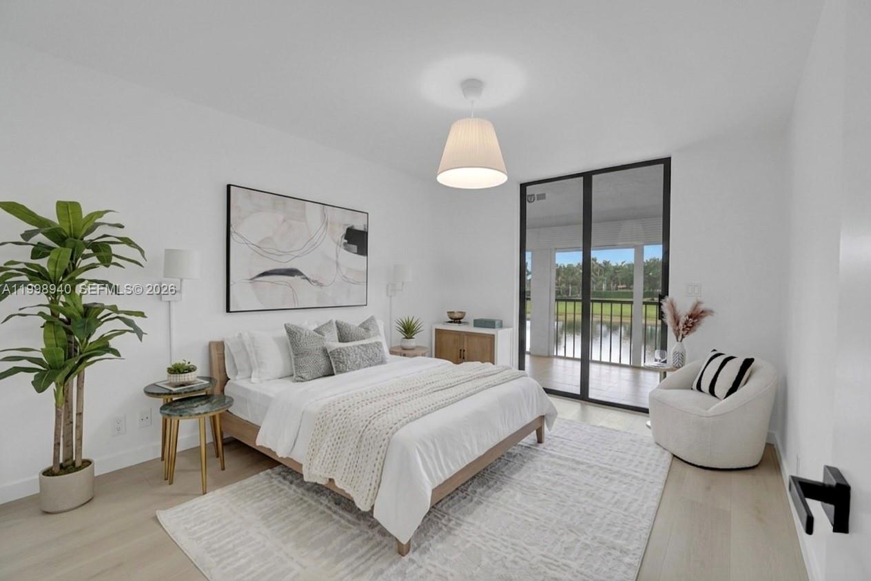7736 La Mirada Drive Boca Raton, FL 33433 - Photo 34 of 56 a bedroom with a large bed and a potted plant