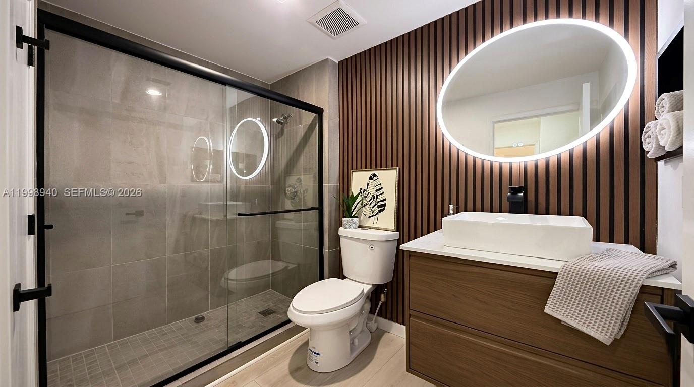 7736 La Mirada Drive Boca Raton, FL 33433 - Photo 35 of 56 a bathroom with a toilet a sink and mirror