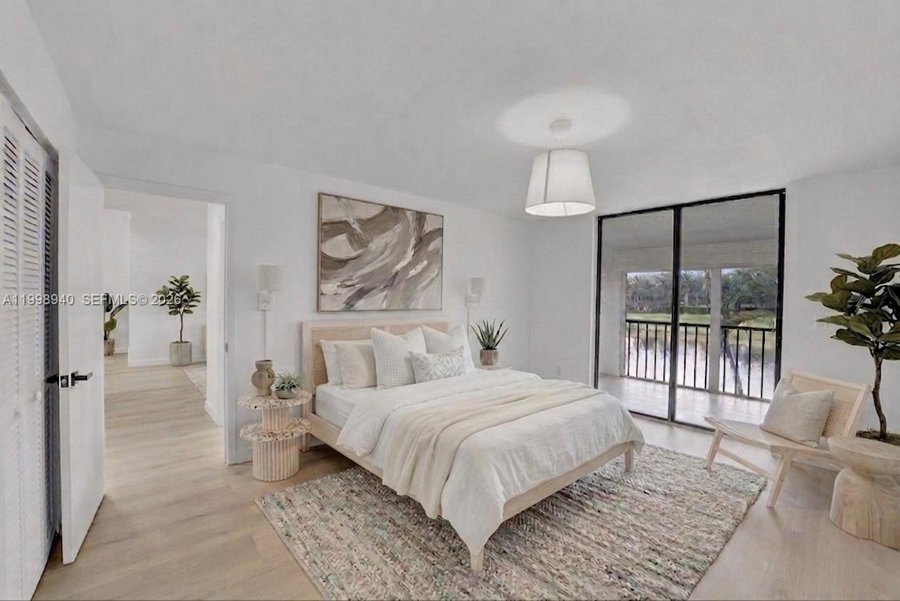 7736 La Mirada Drive Boca Raton, FL 33433 - Photo 36 of 56 a bedroom with a balcony a bed and a painting on the wall