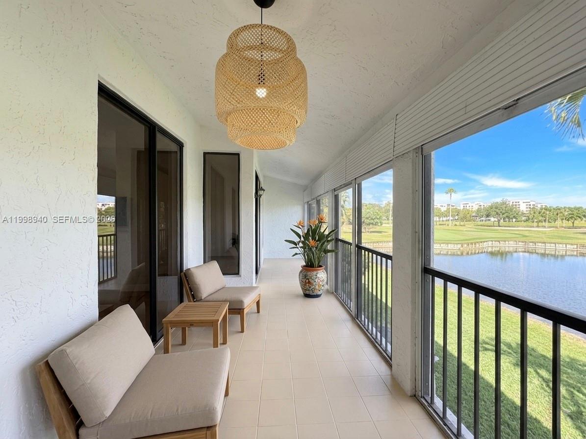 7736 La Mirada Drive Boca Raton, FL 33433 - Photo 39 of 56 a living room with furniture and a floor to ceiling window