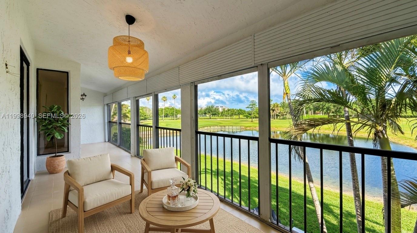 7736 La Mirada Drive Boca Raton, FL 33433 - Photo 41 of 56 a living room with furniture and a floor to ceiling window