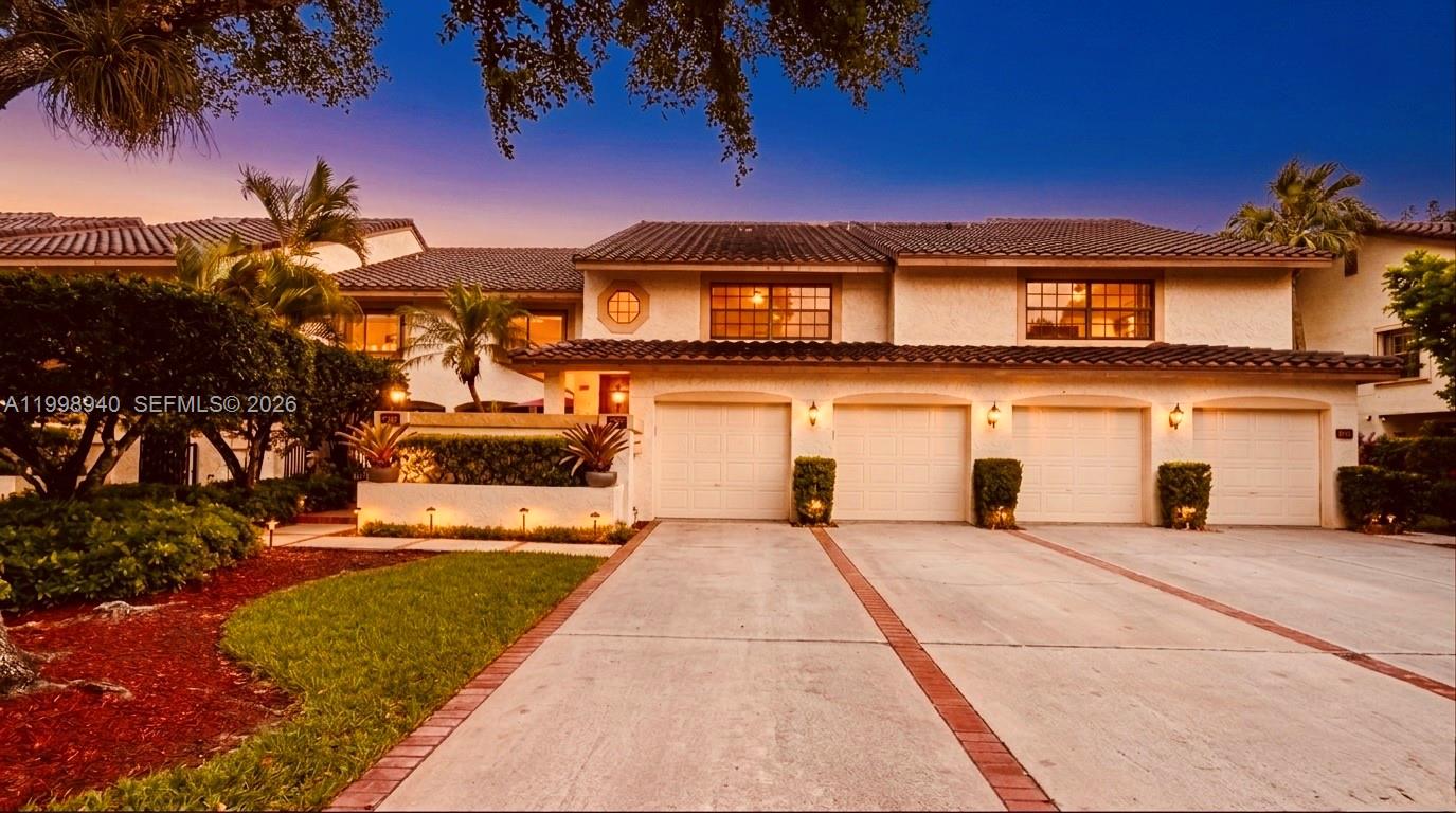 7736 La Mirada Drive Boca Raton, FL 33433 - Photo 49 of 56 a front view of a house with a garden and yard