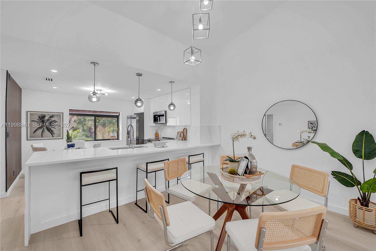 7736 La Mirada Drive Boca Raton, FL 33433 - Photo 7 of 56 a kitchen with a table and chairs in it
