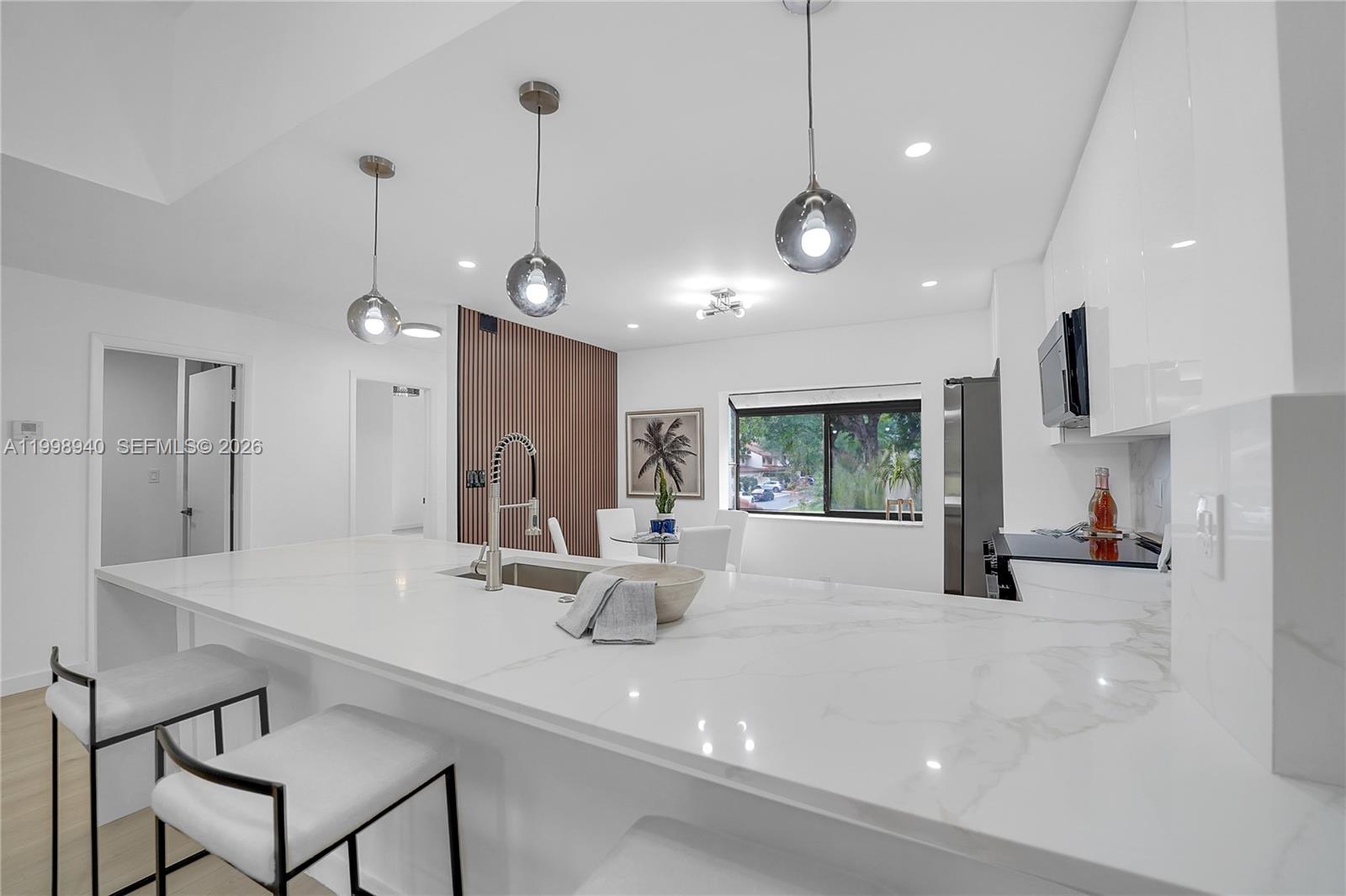 7736 La Mirada Drive Boca Raton, FL 33433 - Photo 8 of 56 a kitchen with a table and chairs in it