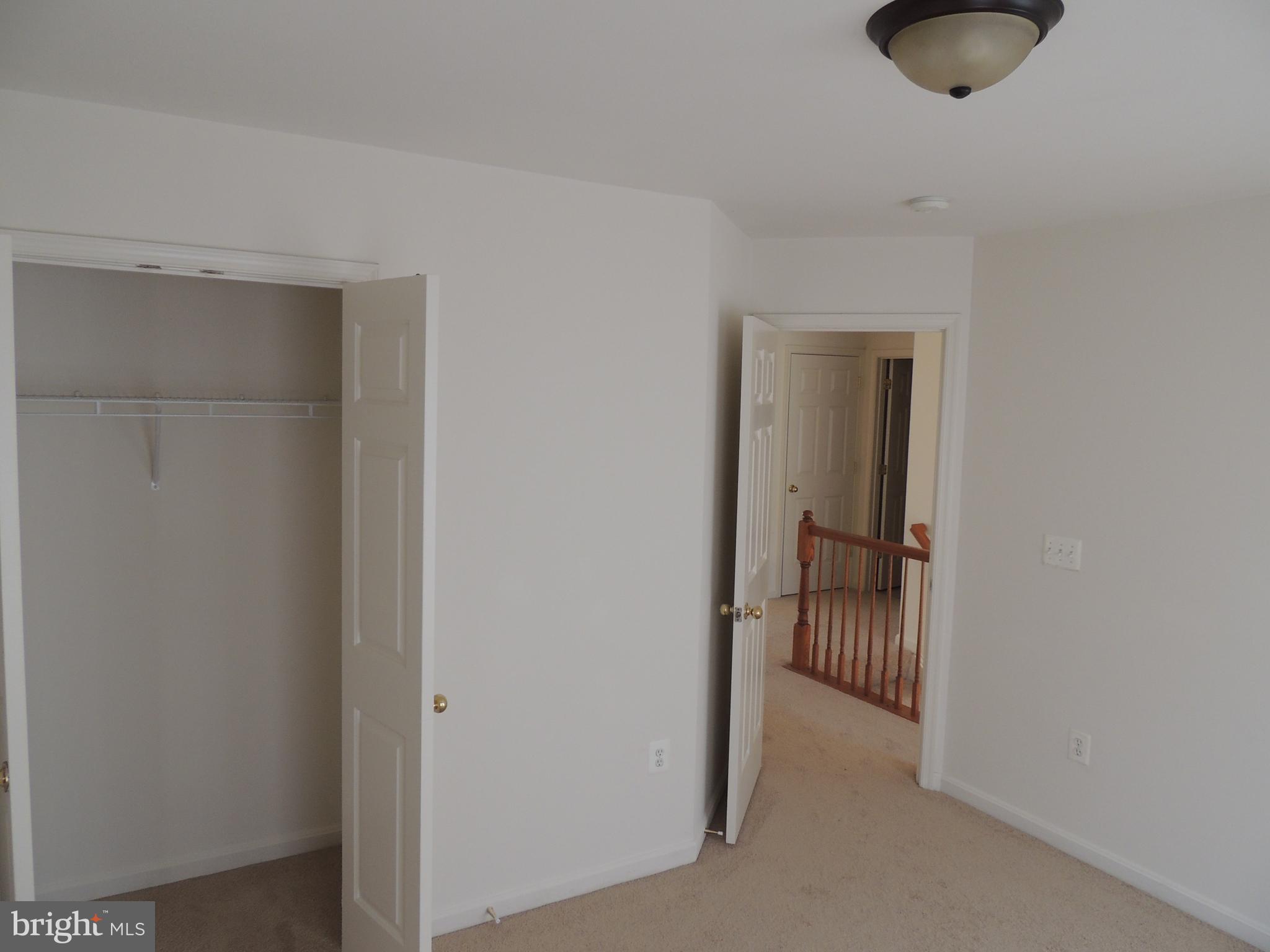 17676 Hampstead Ridge Court Dumfries, VA 22026 - Photo 19 of 22 a hallway with a chair and a door in it