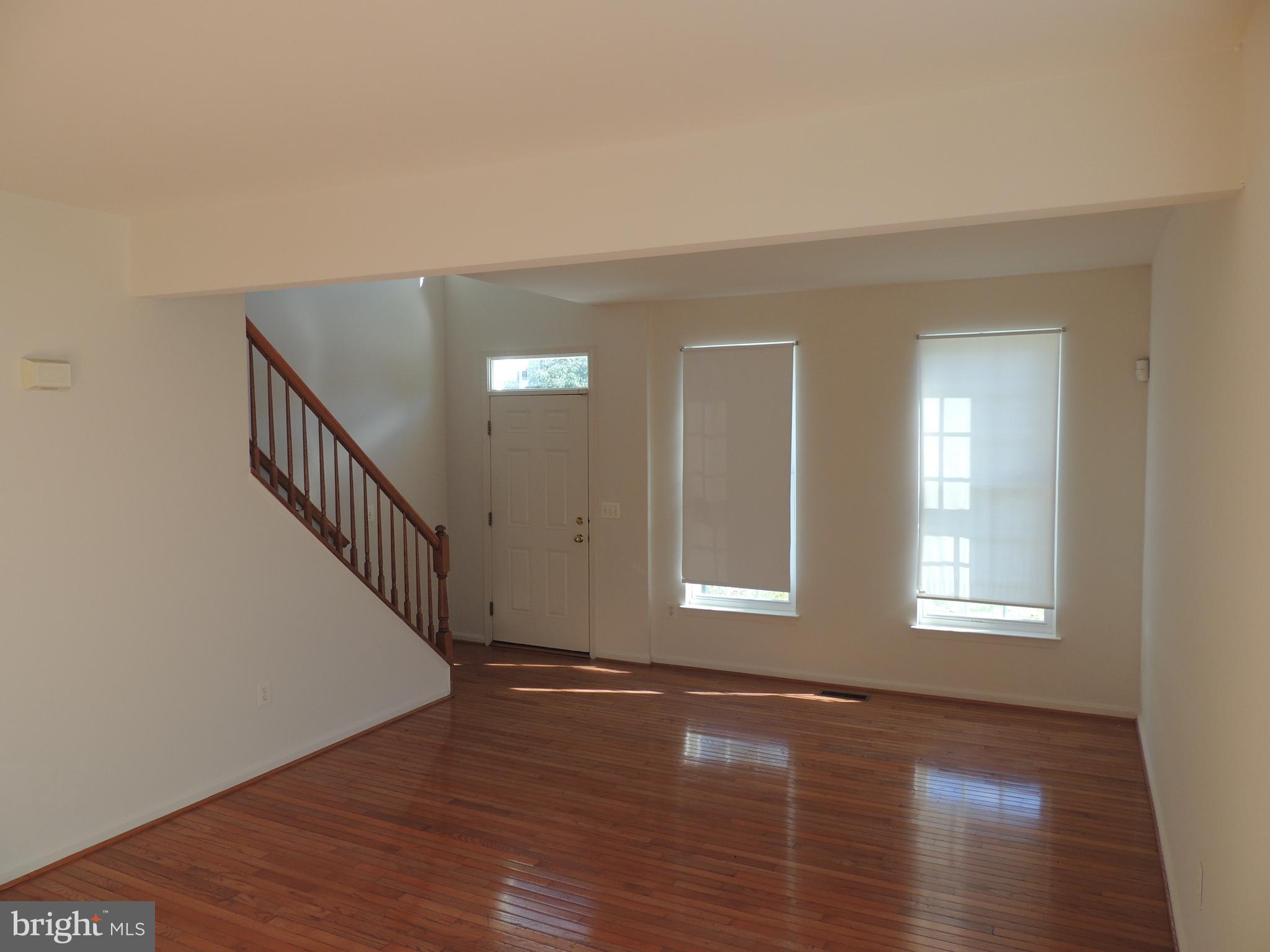 17676 Hampstead Ridge Court Dumfries, VA 22026 - Photo 3 of 22 a view of an empty room with wooden floor and a window