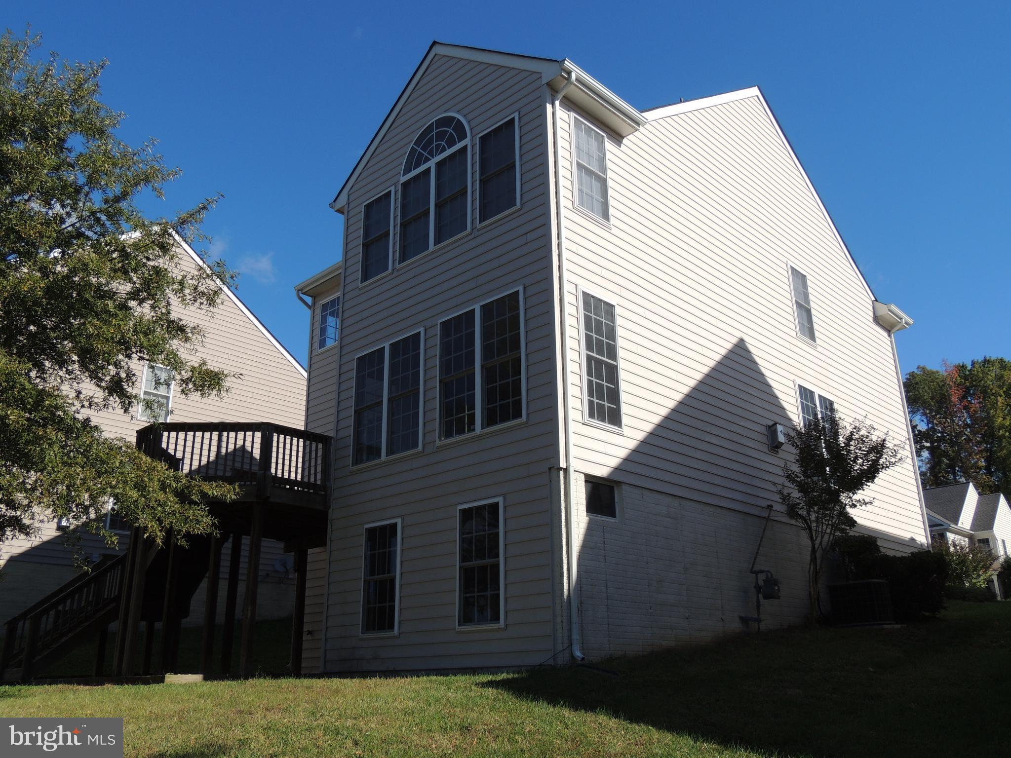 17676 Hampstead Ridge Court Dumfries, VA 22026 - Photo 21 of 22 a view of a house with a yard