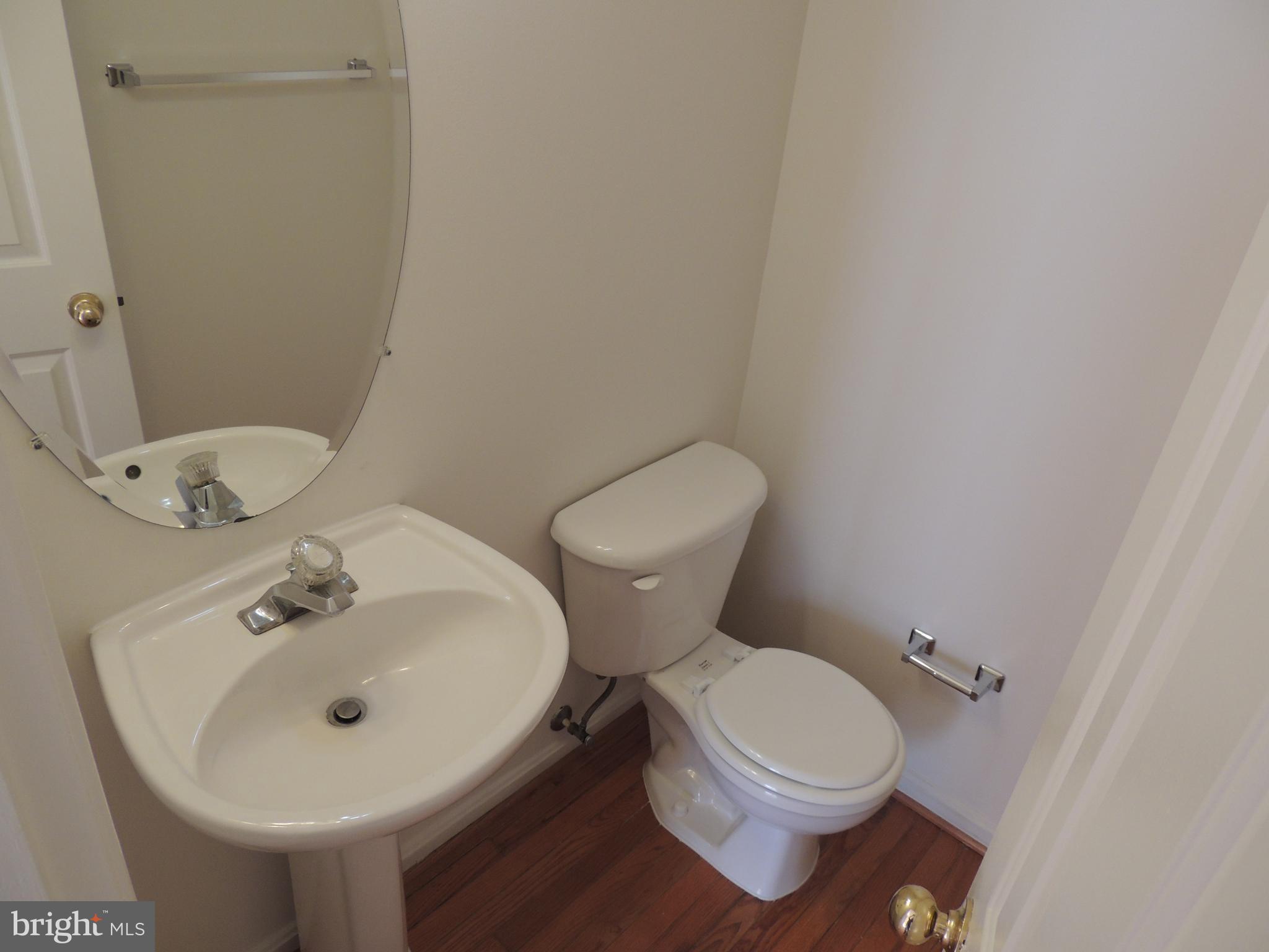 17676 Hampstead Ridge Court Dumfries, VA 22026 - Photo 10 of 22 a white toilet sitting next to a bathroom sink