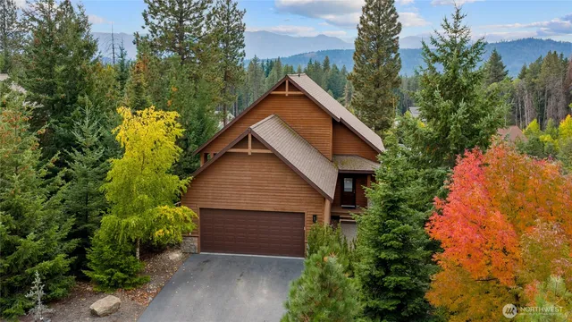 an aerial view of house with yard and trees in the background
