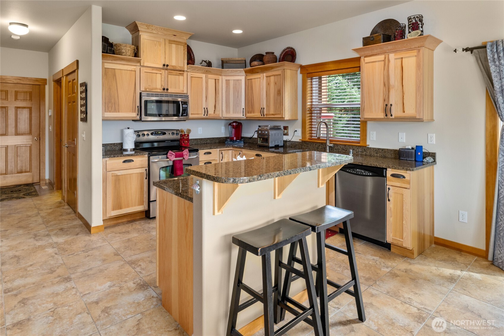 150 Tiger Lily Lane Ronald, WA 98940 - Photo 16 of 40 a kitchen with stainless steel appliances kitchen island granite countertop a refrigerator a stove top oven a sink and dishwasher