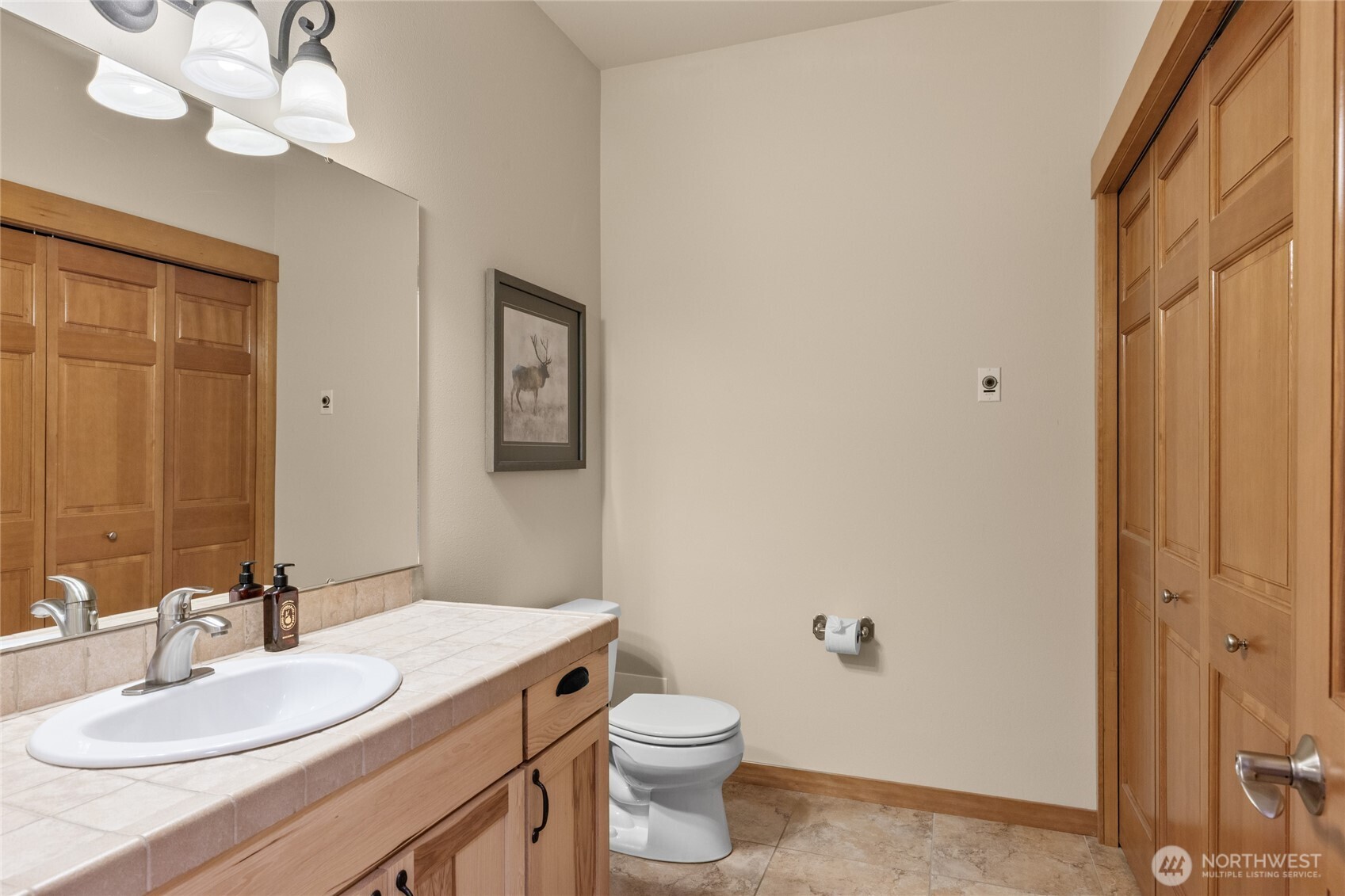150 Tiger Lily Lane Ronald, WA 98940 - Photo 17 of 40 a bathroom with a granite countertop sink a toilet and a mirror