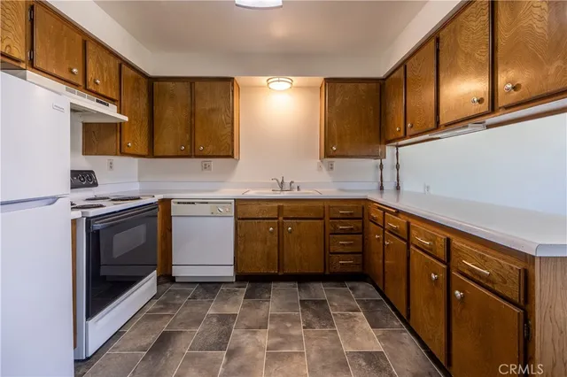 a kitchen with a sink cabinets and window