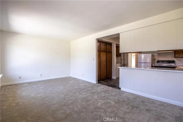 a kitchen with a refrigerator a stove and wooden cabinets