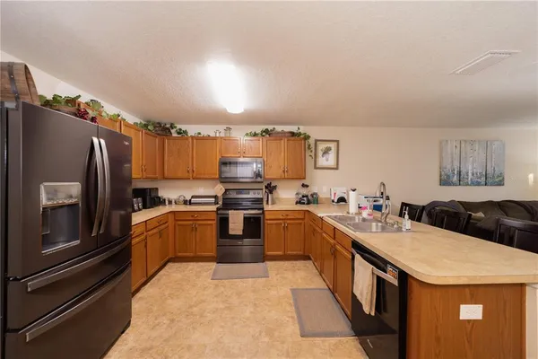 a kitchen with granite countertop stainless steel appliances and wooden cabinets