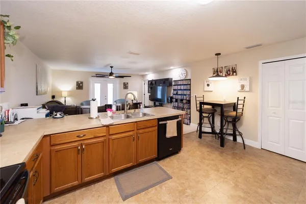 a kitchen with cabinets and chairs in it
