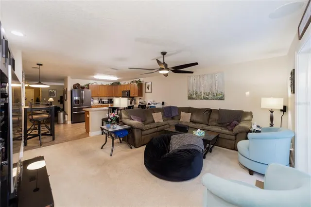 a living room with furniture and kitchen view