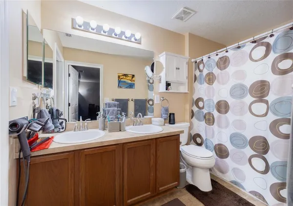 a bathroom with a sink mirror and toilet