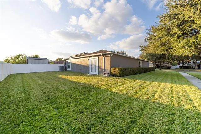 a front view of a house with a garden and yard