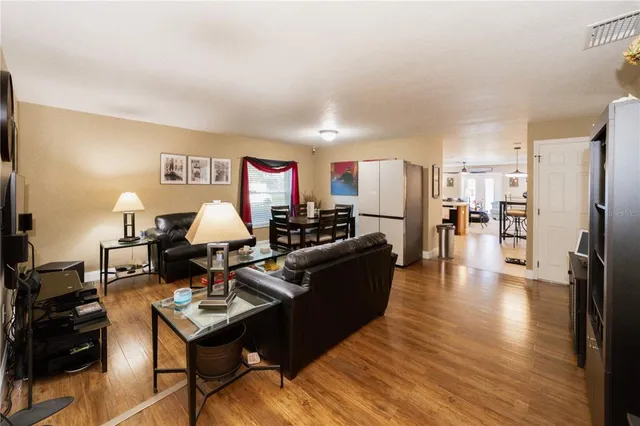 a living room with furniture flat screen tv and a table