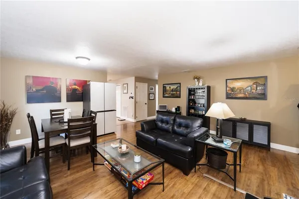 a living room with furniture a wooden floor and a flat screen tv