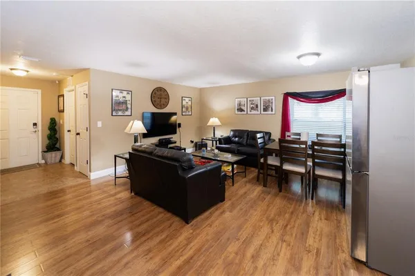 a living room with furniture and a wooden floor