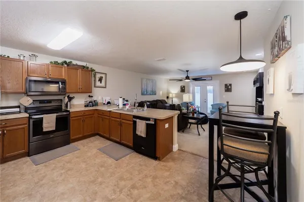 a kitchen with a stove a sink a counter top space and appliances