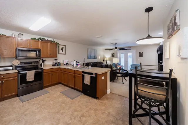 a kitchen with a stove a sink a counter top space and appliances