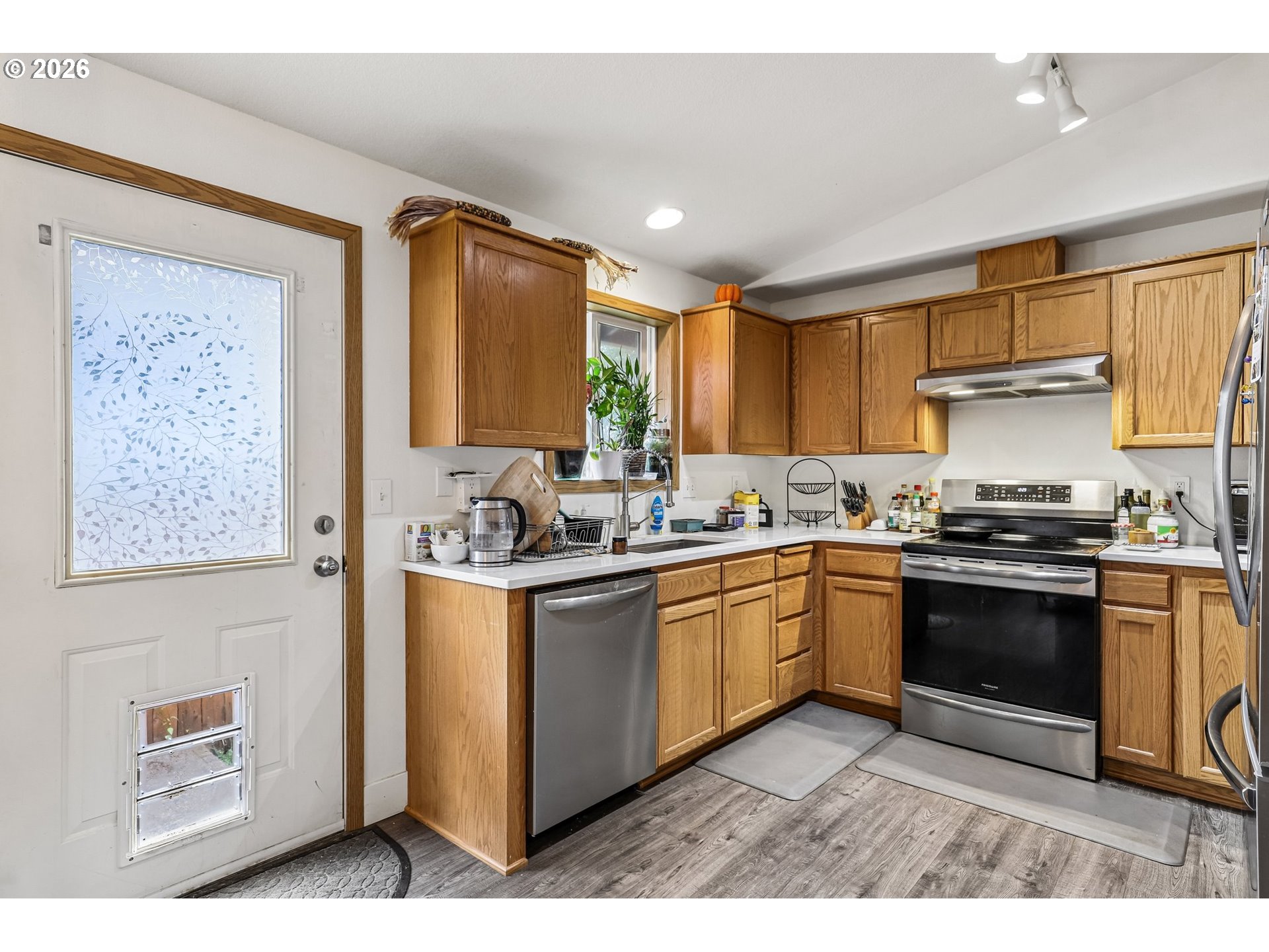 608 Southeast Sumner Street Camas, WA 98607 - Photo 10 of 39 a kitchen with stainless steel appliances granite countertop a stove a sink and a refrigerator